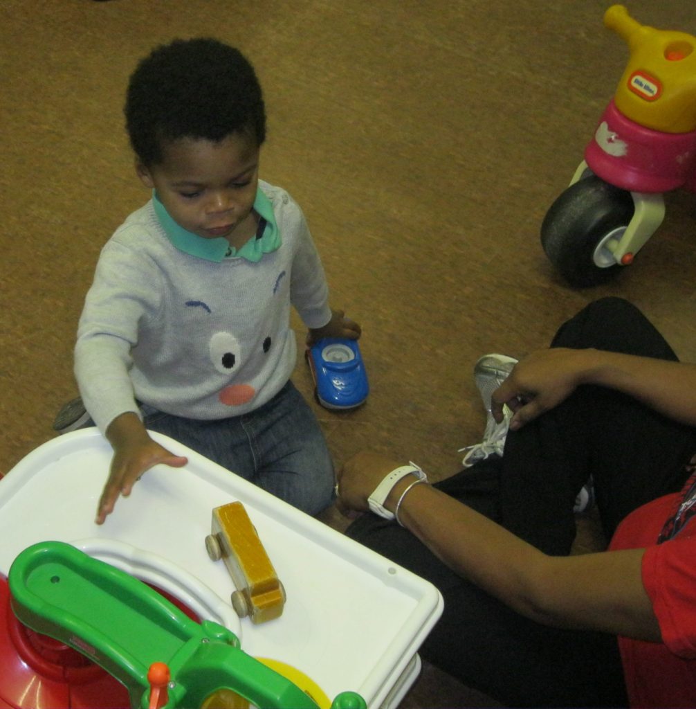 infant with toy truck