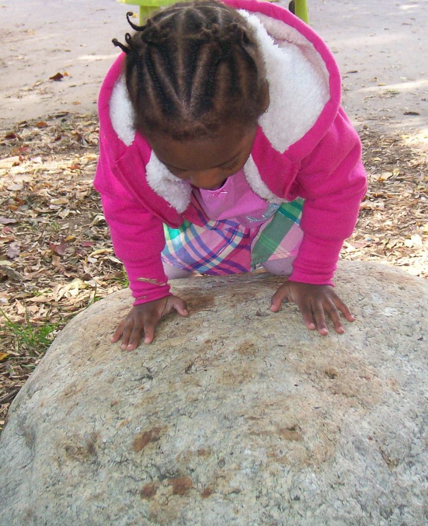 toddler climbing rock