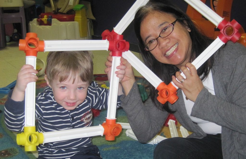 child and Educator playing with frames